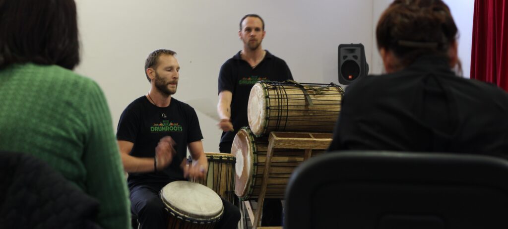 Two men teaching African drums