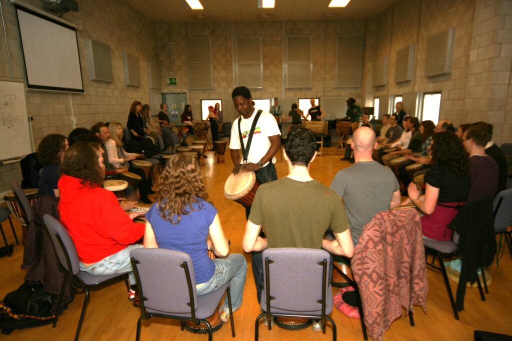 Master drummer Iya Sako teaching a djembe workshop for Drumroots