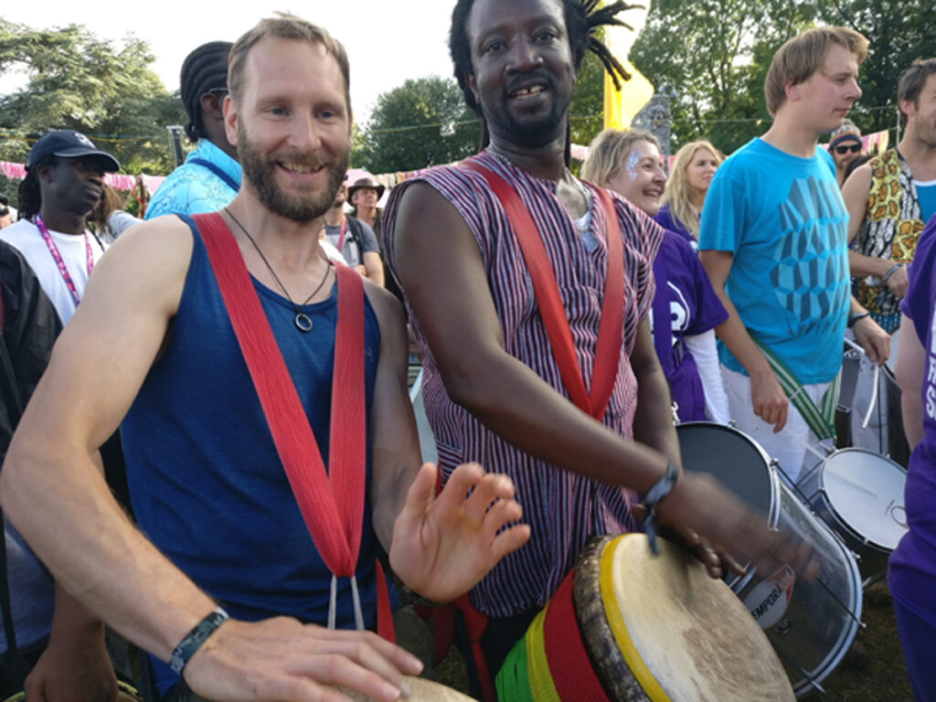 Jamie from Drumroots performing at Womad with Vieux Bakayoko