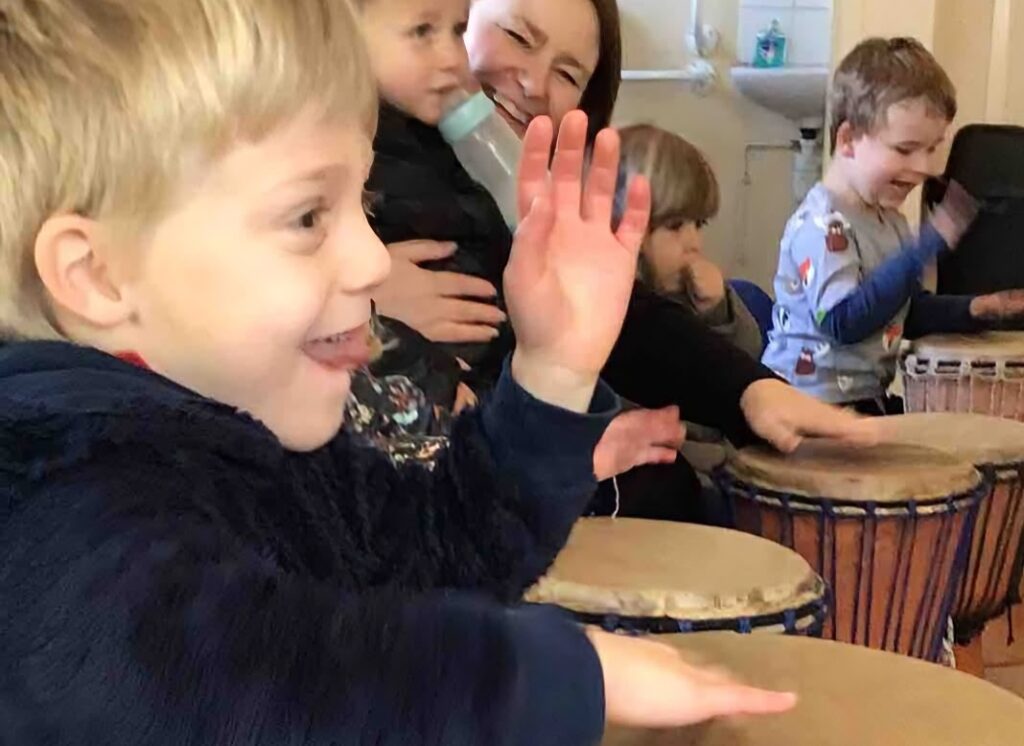 Pre school children playing African drums
